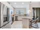 Bright kitchen features stainless appliances, white cabinets, breakfast bar with stylish pendant lighting at 18860 Beautyberry Ct, Lutz, FL 33558