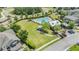 Aerial view of community pool with lounge chairs, gazebo, and manicured lawn at 18860 Beautyberry Ct, Lutz, FL 33558