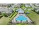 Aerial view of the pool, pool house, seating and other community amenities surrounded by well maintained lawns and landscaping at 18860 Beautyberry Ct, Lutz, FL 33558