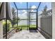 Screened patio with stone-like flooring, an umbrella, and views of the beautiful lake at 18860 Beautyberry Ct, Lutz, FL 33558