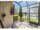 Screened patio with stone floors, an umbrella, and a scenic view of the lake at 18860 Beautyberry Ct, Lutz, FL 33558