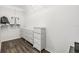 Walk-in closet with white shelving and drawers and wood floor at 18860 Beautyberry Ct, Lutz, FL 33558