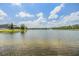 Scenic view of a large lake reflecting the sky, with a fountain in the distance at 18860 Beautyberry Ct, Lutz, FL 33558