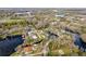 Aerial view of a lakeside home with a private dock, nestled in a peaceful community near the water at 18914 5Th St, Lutz, FL 33548