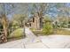 Rear exterior with a screened in porch, view of the lake, well maintained yard and landscaping at 18914 5Th St, Lutz, FL 33548