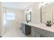 Modern bathroom featuring double sinks, quartz countertops, and a walk-in shower at 18914 5Th St, Lutz, FL 33548