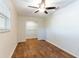 Bedroom with wood flooring, a ceiling fan, and a closet at 18914 5Th St, Lutz, FL 33548