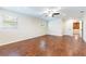 A spacious bedroom with hardwood floors, a ceiling fan, and a double window at 18914 5Th St, Lutz, FL 33548