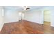 A spacious bedroom with hardwood floors, a ceiling fan, and a large walk-in closet at 18914 5Th St, Lutz, FL 33548