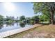 Waterfront home boasting a private dock with a covered boat lift, ideal for boating and enjoying the lake at 18914 5Th St, Lutz, FL 33548