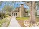 Charming exterior view of a home with a screened porch and a large tree at 18914 5Th St, Lutz, FL 33548