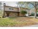 Two-story home featuring a stone facade, covered porch, mature landscaping, and a convenient attached two-car garage at 18914 5Th St, Lutz, FL 33548