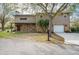 Charming home with stone accents, an attached garage, mature trees, and a well-maintained lawn at 18914 5Th St, Lutz, FL 33548