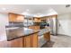 Open kitchen features granite countertops, gray tile backsplash, and stainless steel appliances at 18914 5Th St, Lutz, FL 33548