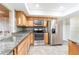 Eat-in kitchen features stainless steel appliances and granite counters at 18914 5Th St, Lutz, FL 33548