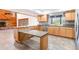 Spacious kitchen with granite countertops and stainless steel dishwasher, overlooking a living space at 18914 5Th St, Lutz, FL 33548