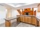 Large eat-in kitchen featuring an island with granite countertops next to a fireplace at 18914 5Th St, Lutz, FL 33548