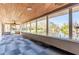 Enclosed porch with views of the water, a wood ceiling, and modern tile flooring at 18914 5Th St, Lutz, FL 33548