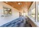 Enclosed porch with views of the water, a wood ceiling, and modern tile flooring at 18914 5Th St, Lutz, FL 33548