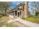 Rear exterior with a screened in porch, well maintained yard and access to the chimney at 18914 5Th St, Lutz, FL 33548