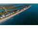 Stunning aerial view of the coastline with white sandy beach and blue ocean at 19111 Vista Bay Dr # 304, Indian Shores, FL 33785