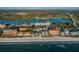 Stunning aerial view of beachfront condos, with white sand and blue ocean at 19111 Vista Bay Dr # 304, Indian Shores, FL 33785