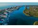 Aerial view of a coastal community featuring waterfront properties, a river, and lush green mangroves at 19111 Vista Bay Dr # 304, Indian Shores, FL 33785