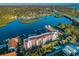 Expansive aerial perspective showcasing the building with red roofs and a community by the tranquil waterfront at 19111 Vista Bay Dr # 304, Indian Shores, FL 33785
