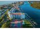 Aerial view of a waterfront condominium building with tennis courts, docks, and boat slips at 19111 Vista Bay Dr # 304, Indian Shores, FL 33785