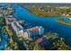 Aerial view of the Vista Bay condo on a waterway offering a tennis court, boat docks, and beautiful landscaping at 19111 Vista Bay Dr # 304, Indian Shores, FL 33785