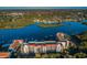 Stunning aerial shot of the building with red roofs, surrounding community, water access, and lush greenery at 19111 Vista Bay Dr # 304, Indian Shores, FL 33785