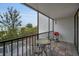 Cozy screened balcony features tiled flooring and a bistro table with seating for two at 19111 Vista Bay Dr # 304, Indian Shores, FL 33785