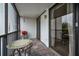 Enclosed balcony with bistro table and partial view of an additional patio at 19111 Vista Bay Dr # 304, Indian Shores, FL 33785