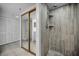 Bathroom featuring a tiled walk-in shower, and access to the closet and bedroom at 19111 Vista Bay Dr # 304, Indian Shores, FL 33785