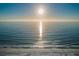 Stunning beachfront view with white sand, gentle waves, and bright sunlight reflecting on the water at 19111 Vista Bay Dr # 304, Indian Shores, FL 33785