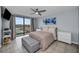 Bright bedroom featuring a comfortable bed, stylish decor, and balcony access with a scenic view at 19111 Vista Bay Dr # 304, Indian Shores, FL 33785