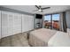 Bright bedroom boasts a ceiling fan, balcony access, and ample storage with large closets at 19111 Vista Bay Dr # 304, Indian Shores, FL 33785