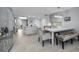 Open concept dining area with a modern table, seating bench, and convenient access to the kitchen at 19111 Vista Bay Dr # 304, Indian Shores, FL 33785