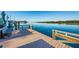 Wooden dock with a bench overlooking a peaceful waterway with boats and lush scenery at 19111 Vista Bay Dr # 304, Indian Shores, FL 33785