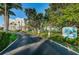 Entrance to Vista Bay with lush trees and landscaping along the drive at 19111 Vista Bay Dr # 304, Indian Shores, FL 33785