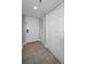 Clean and simple hallway featuring neutral tones, tile flooring, and closet space at 19111 Vista Bay Dr # 304, Indian Shores, FL 33785