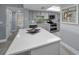 Kitchen featuring gray cabinets, white quartz countertops, an island and stainless steel appliances, including a double oven at 19111 Vista Bay Dr # 304, Indian Shores, FL 33785