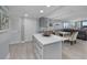 Open floor plan showing the kitchen with an island that adjoins the dining and living area at 19111 Vista Bay Dr # 304, Indian Shores, FL 33785