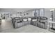 Relaxing living room with a large gray sectional, neutral paint, and modern decorations for a comfortable living space at 19111 Vista Bay Dr # 304, Indian Shores, FL 33785
