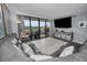 Modern living room showcasing a large sectional sofa and a view from the balcony at 19111 Vista Bay Dr # 304, Indian Shores, FL 33785