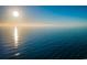 Expansive ocean view featuring a clear blue sky, calm water, and the sun reflecting on the horizon at 19111 Vista Bay Dr # 304, Indian Shores, FL 33785