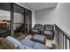 A cozy outdoor patio with blue cushioned seating and a view from the balcony at 19111 Vista Bay Dr # 304, Indian Shores, FL 33785