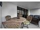 Outdoor seating area with a round table, four chairs, and two cushioned wicker chairs at 19111 Vista Bay Dr # 304, Indian Shores, FL 33785