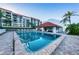 Beautiful community pool with lounge chairs and gathering space next to the condominium building at 19111 Vista Bay Dr # 304, Indian Shores, FL 33785