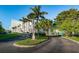 View of the building and street, showcasing well-maintained landscaping and easy access to the beach at 19111 Vista Bay Dr # 304, Indian Shores, FL 33785
